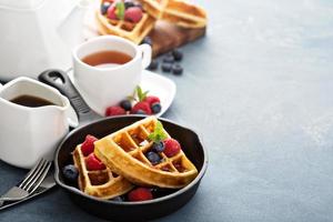 Freshly baked waffles with berries for breakfast photo