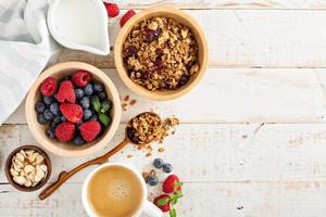 Breakfast table with granola and fresh berries photo