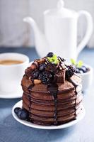Stack of chocolate pancakes with toppings photo