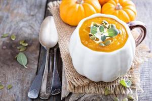 Pumpkin soup with cream, herbs and seeds photo