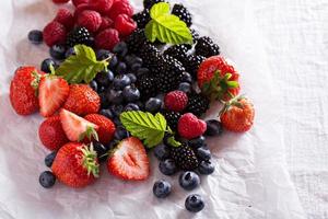 Variety of summer berries on white photo