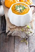 Pumpkin soup with cream, herbs and seeds photo