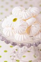 Meringue kisses cookies on a cake stand photo