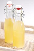 Homemade ginger ale in two glass bottles photo