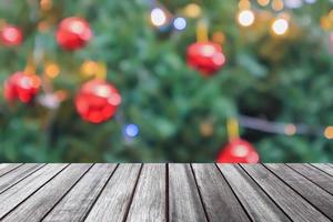 Empty wood table top with blur Christmas tree with bokeh light background photo