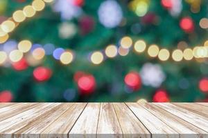 Empty wood table top with blur Christmas tree with bokeh light background photo