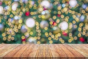 Empty wood table top with blur Christmas tree with bokeh light background photo