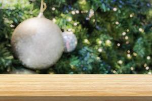 Empty wood table top with blur Christmas tree with bokeh light background photo