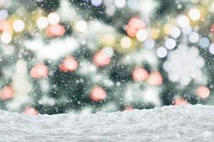 Empty white snow with blur Christmas tree with bokeh light background photo