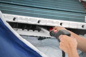 air conditioning cleaning service with water spray photo