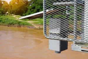 Solar automatic water metering station or water level meter used to measure the water level of the river to help alert villagers to watch out for flooding if the flood level reaches the meter. photo