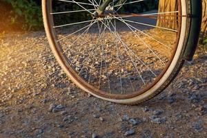 Old bicycle wheels, flat tires, left outside for a long time until rust on the metal parts. Soft and selective focus. photo