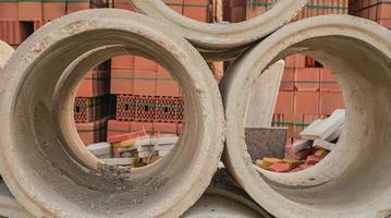 Concrete circles for a well and construction. Goods in stock, construction and repair of houses, delivery and sale of building materials. photo