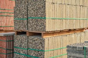 Paving slabs on pallets in keeping. Goods in stock, construction and repair, delivery and sale of building materials. photo