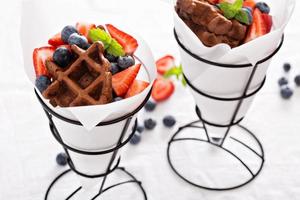 Small chocolate waffles in cones photo