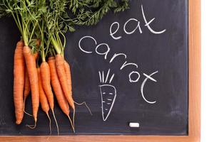 Fresh carrot with green leaves photo