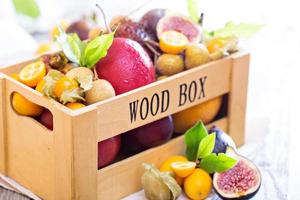 Exotic fruits in a wooden crate photo