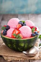 Refreshing berry sorbet served in watermelon photo