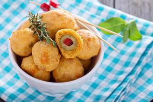 Appetizer Olives baked in cheddar dough photo