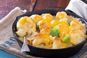 Cauliflower with cheese baked in a pan photo