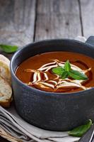 Spicy tomato cream soup with bread photo