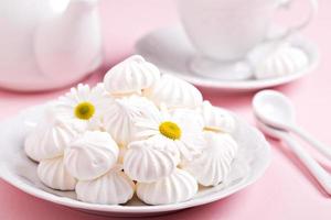 Meringue kisses cookies on a white plate photo