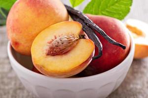 Fresh peaches in a bowl photo