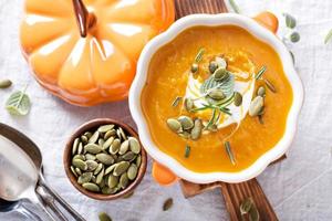 Pumpkin soup with cream, herbs and seeds photo