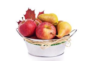 Apples and pears in metal bucket with autumn leaf photo