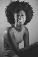 Black and white photograph of cheerful black model looking at camera photo