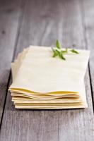 Lasagna sheets stacked on table photo