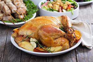 Whole roasted chicken on dinner table photo