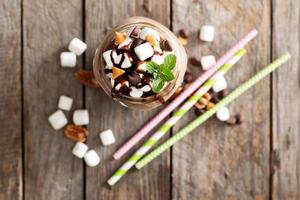 Chocolate shake with sauce and marshmallows photo