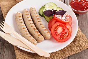 Grilled pork sausages on a plate photo