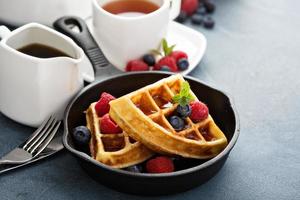 Freshly baked waffles with berries for breakfast photo