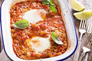 Baked eggs with vegetables and chickpeas photo