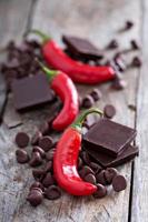 Dark chocolate pieces and chips with hot chilli pepper photo