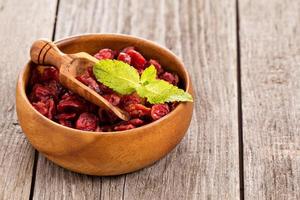 Dried cranberries in a wooden bowl photo