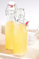 Homemade ginger ale in two glass bottles photo