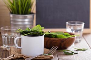Green spinach leaves in a mug