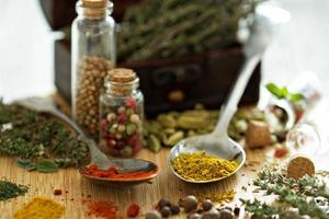 Variety of spices and herb on a wooden board photo
