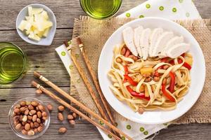 Udon noodles with vegetables and chicken photo