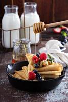 Thin pancakes with apples and fresh berry photo