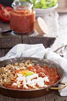 Shakshuka with tomatoes and eggs photo