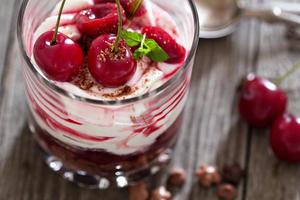 Sweet cherry cheesecake in a glass photo