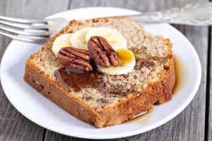 Banana bread with pecan nuts cut on the table photo