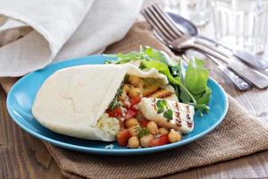 Pita bread with couscous and chickpeas photo