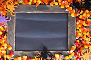 Halloween candy frame around chalk board photo