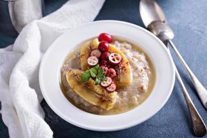 Multigrain porridge with bananas and cranberry photo