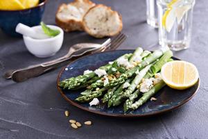 Warm salad with asparagus, feta cheese and lemon photo